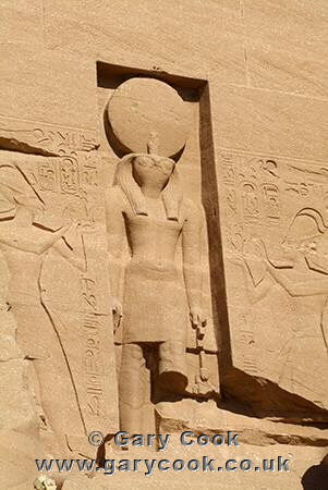 Falcon headed sun god Ra, between the heads of the colossal statues of Ramses II at Abu Simbel, Egypt