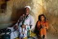 Egyptian man smoking a sheesha pipe and his daughter, Siwa, Egypt