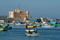 Fishing boats in the Eastern Harbour, looking towards the Fortress of Qaitbey, Alexandria, Egypt