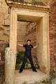 Tourist in the doorway in the Severan Basilica, Leptis Magna Roman Ruins, Libya