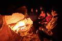 Group sitting around the campfire, bush camp in the Sahara Desert, Libya