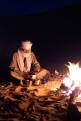 Tuareg man making tea by the camp fire, Sahara Desert, Libya