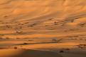 Tourists enjoying the view of the Idehan Ubari sand sea at sunset, Sahara Desert, Libya
