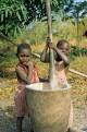 Young girls helping to pound cassava, Kande, Malawi