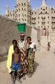 Fulani girls posing in front of the mosque, near Mopti, Mali