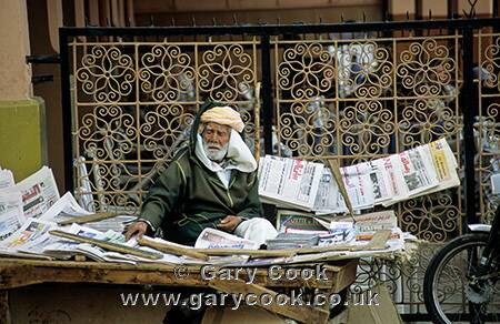 Berber man selling newspapers, Marrakesh, Morocco