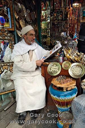 Berber man tending his stall, reading a newspaper, Medina, Tunis, Tunisia