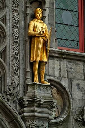 Golden figures decorate the exterior of the Heilig Bloedbasiliek, Basilica of the Holy Blood, Burg square, Bruges, Brugge, Belgium