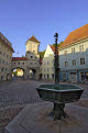 Fountain and the Sandauertor (Sandau Gateway) in the city walls, Landsberg am Lech, Bavaria, Germany