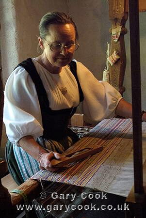 Woman weaving on a traditional loom, Freilicht Ballenberg Open-air Museum, near Brienz, Bernese Oberland, Central Switzerland