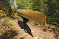 Carrying the canoe along a portage in the Boundary Waters Canoe Area Wilderness, Superior National Forest, Minnesota, USA