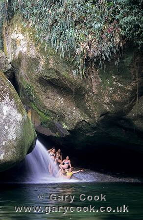 Tourists enjoying the waterfalls of Serra dos Orgaos NP, Teresopolis, near Rio de Janeiro, Brazil