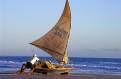 Fisherman pushing his boat out to sea, Canoa Quebrada beach, Ceara, north east Brazil