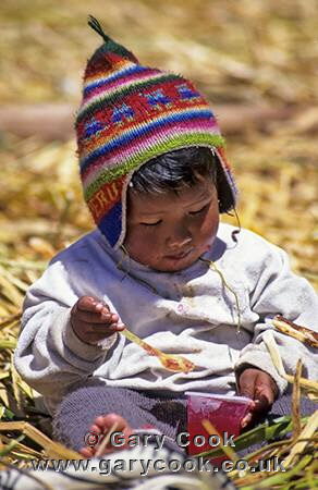 Uros Indian child enjoys a jelly, Lake Titicaca, Peru