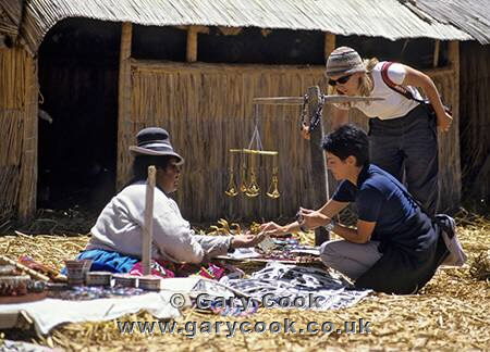 Tourists shopping for souvenirs, Uros Indians reed islands, Lake Titicaca, Peru