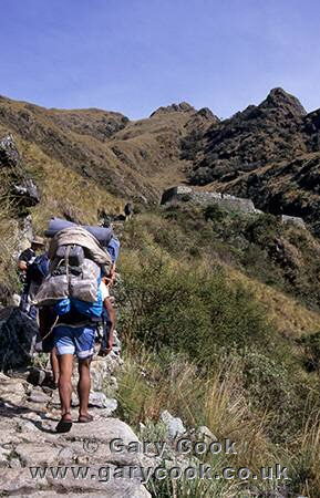 Porters climbing towards Runkurakay Pass, Inca Trail, Peru