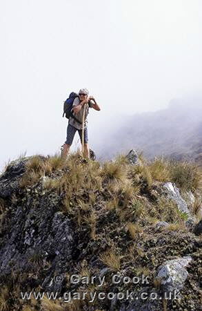 Tourist taking a well earned rest, Runkurakay Pass, Inca Trail, Peru