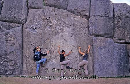 Tourists admiring the Inca stonework, Sacsayhuaman, Peru